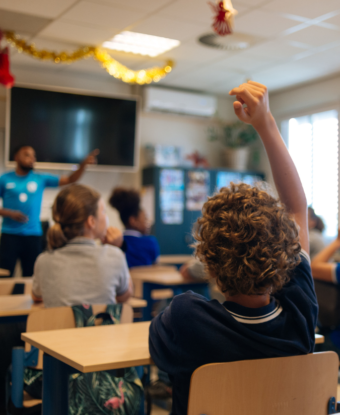 A Student Raising Their Hand In Class